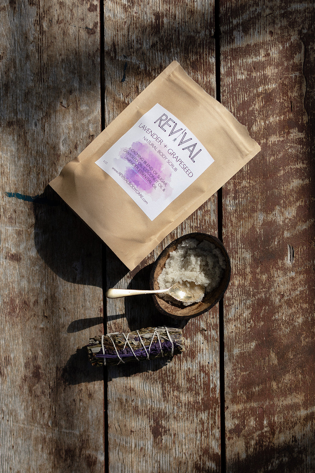 Revival product packaging on a wooden surface with a spoon and small bowl.