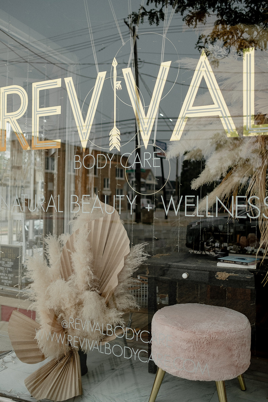 Gold sign reading 'REVIVAL' with decorative elements inside a store.