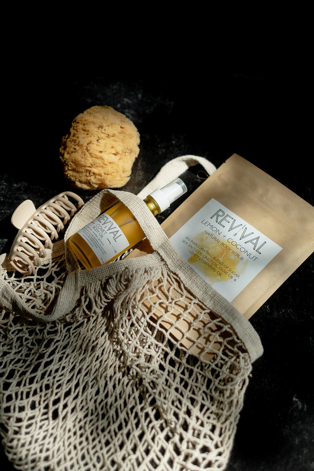 Bottle of Revival with packaging on a textured surface