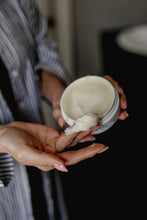 Person applying Revival Lush Locks from a jar to their hand