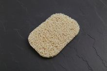 A beige bar soap saver with a porous texture, designed to hold bar soap.