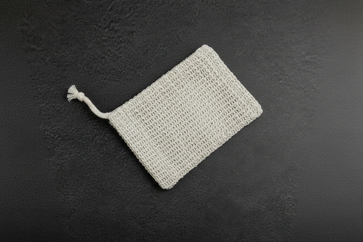 A beige sisal soap sack with a textured surface and a drawstring.